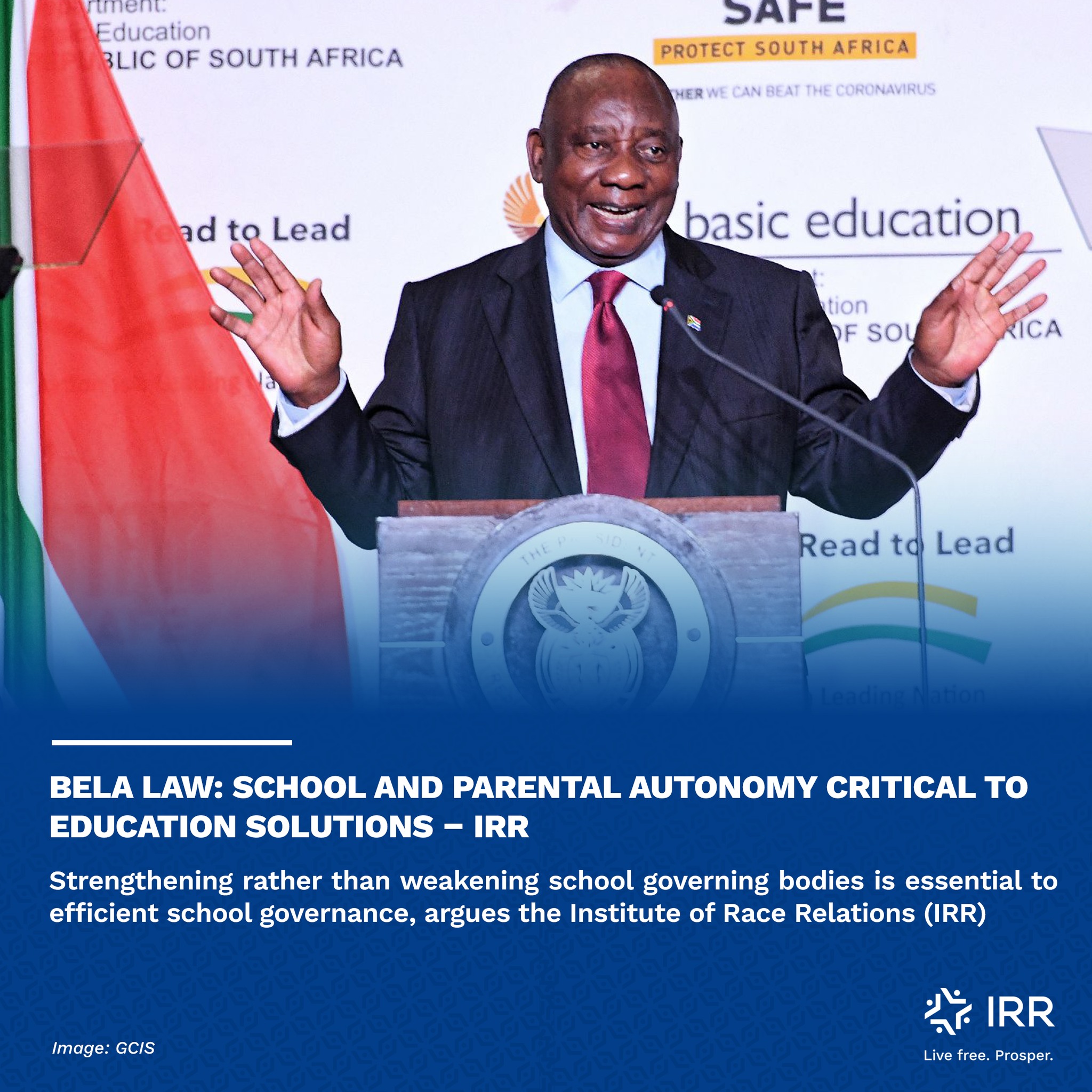A photograph of Cyril Ramaphosa speaking at a Department of 
													Basic Education event. He is standing at a podium with his hands outstretched.