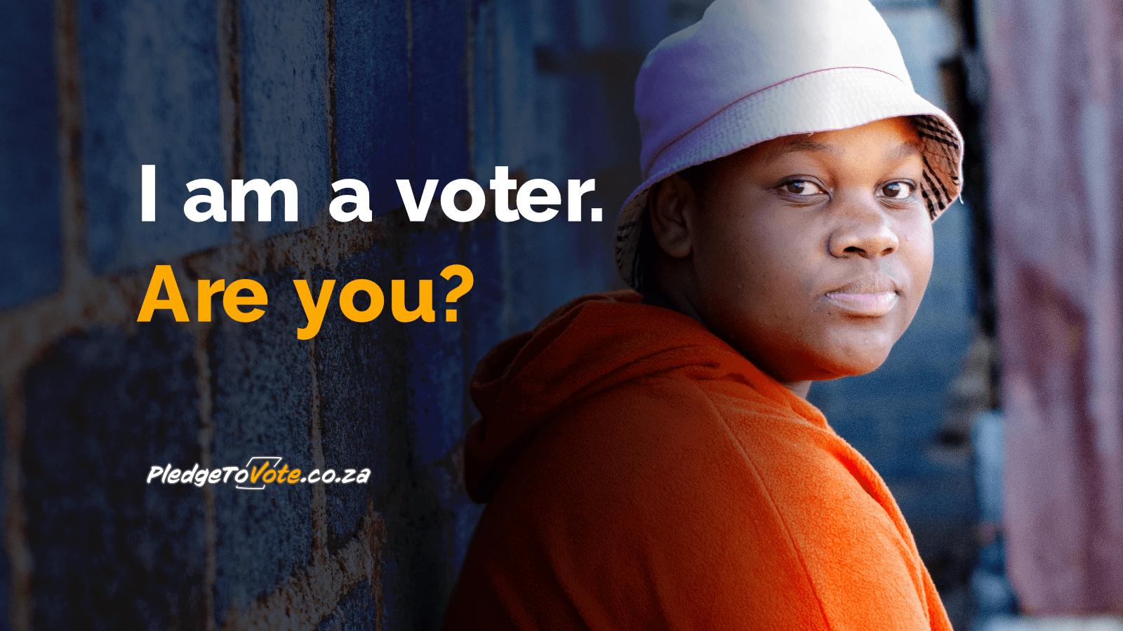 A photo of a young black woman wearing a pink bucket hat and orange hoodie, 
														leaning against a wall and looking into the camera. The photo is overlaid 
														with the following text: “I am a voter. Are you?